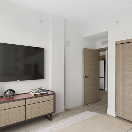 Relax and recharge in beautiful and spacious bedrooms a room with a tv and a table