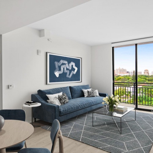 Generous living spaces with beautiful natural lighting a living room with a couch and a table